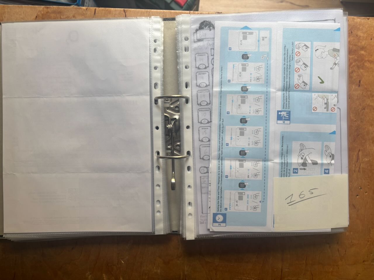 A picture of a binder with several clear
plastic sleeves housing documents, with a number on a piece of scrap paper
inserted on the front.